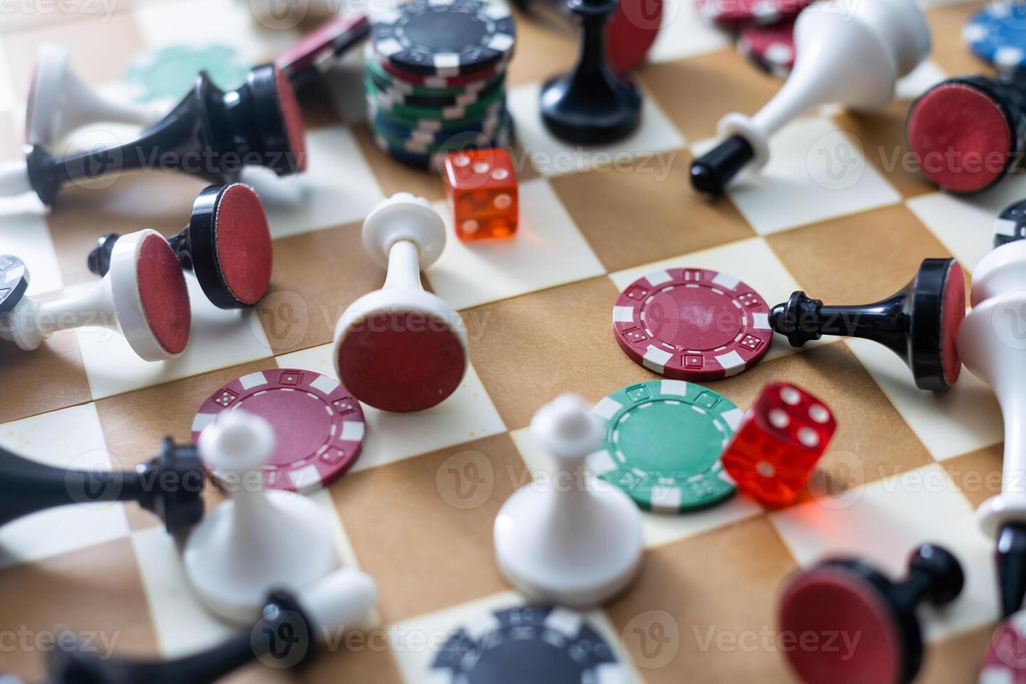 Wooden checkers, chess pieces, playing cards, board games on a light table close up. photo