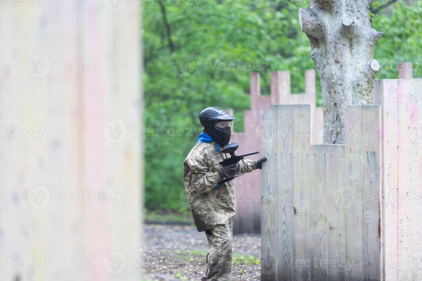 kids team play paintball on the field photo
