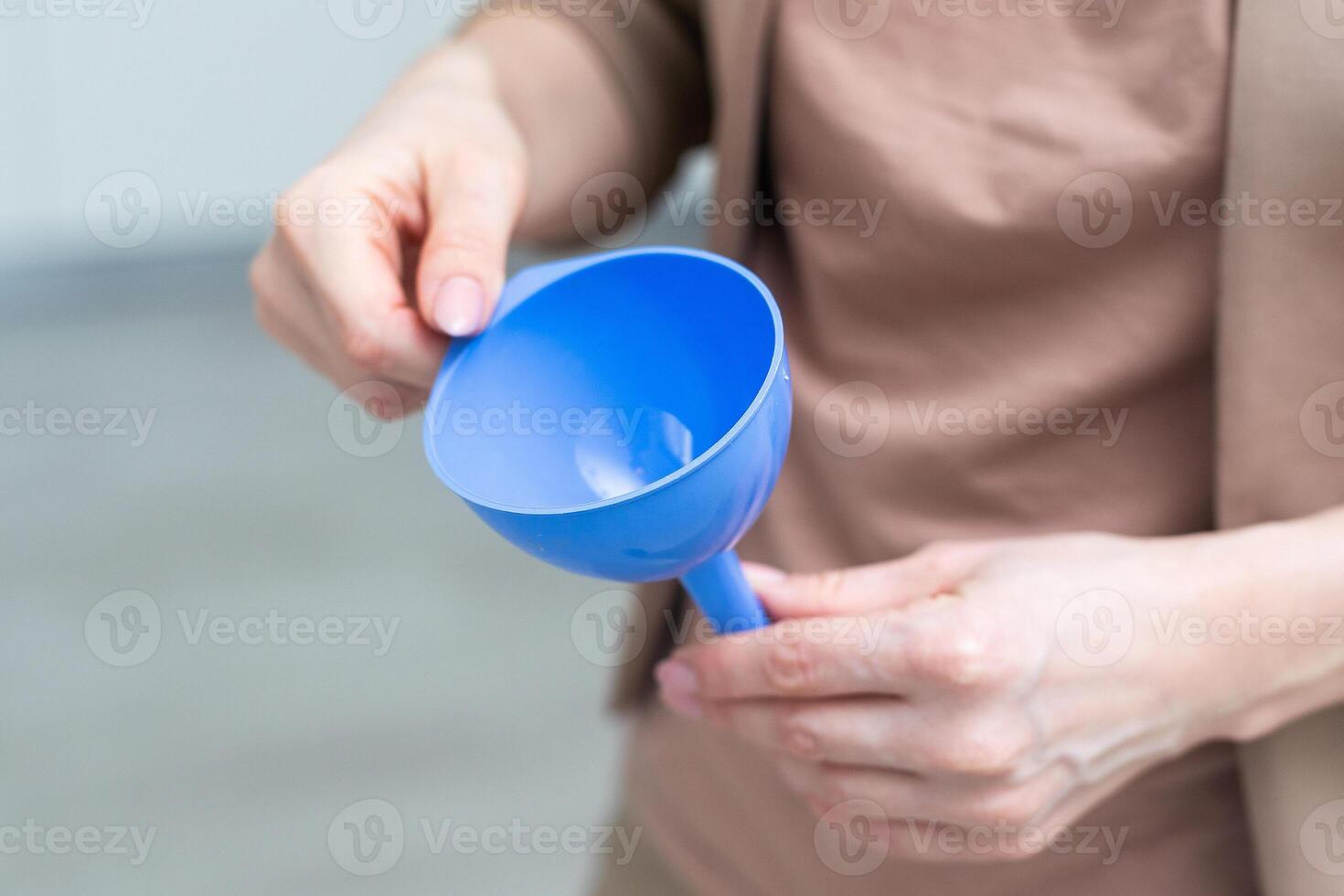 hand holds a funnel isolated on white background photo