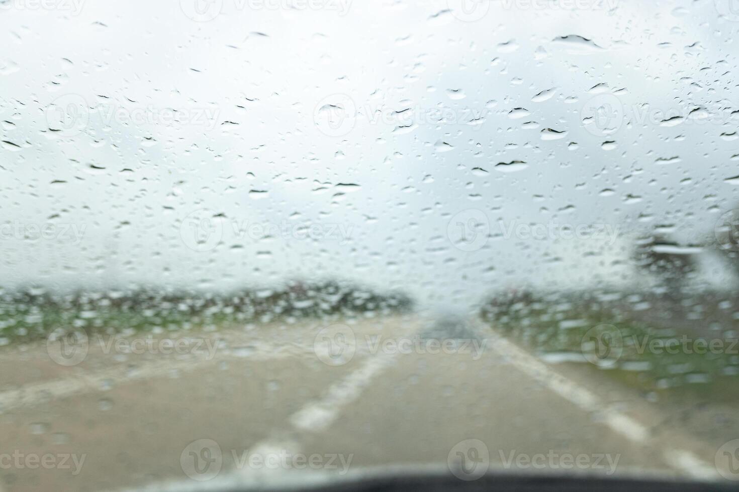 selective focus of raindrops on the windshield of a car in a fall storm photo