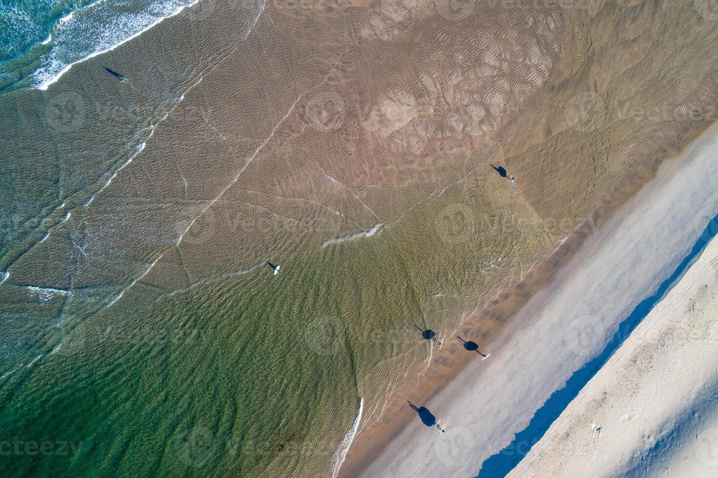 drone aerial view of a turquoise water beach at dawn photo