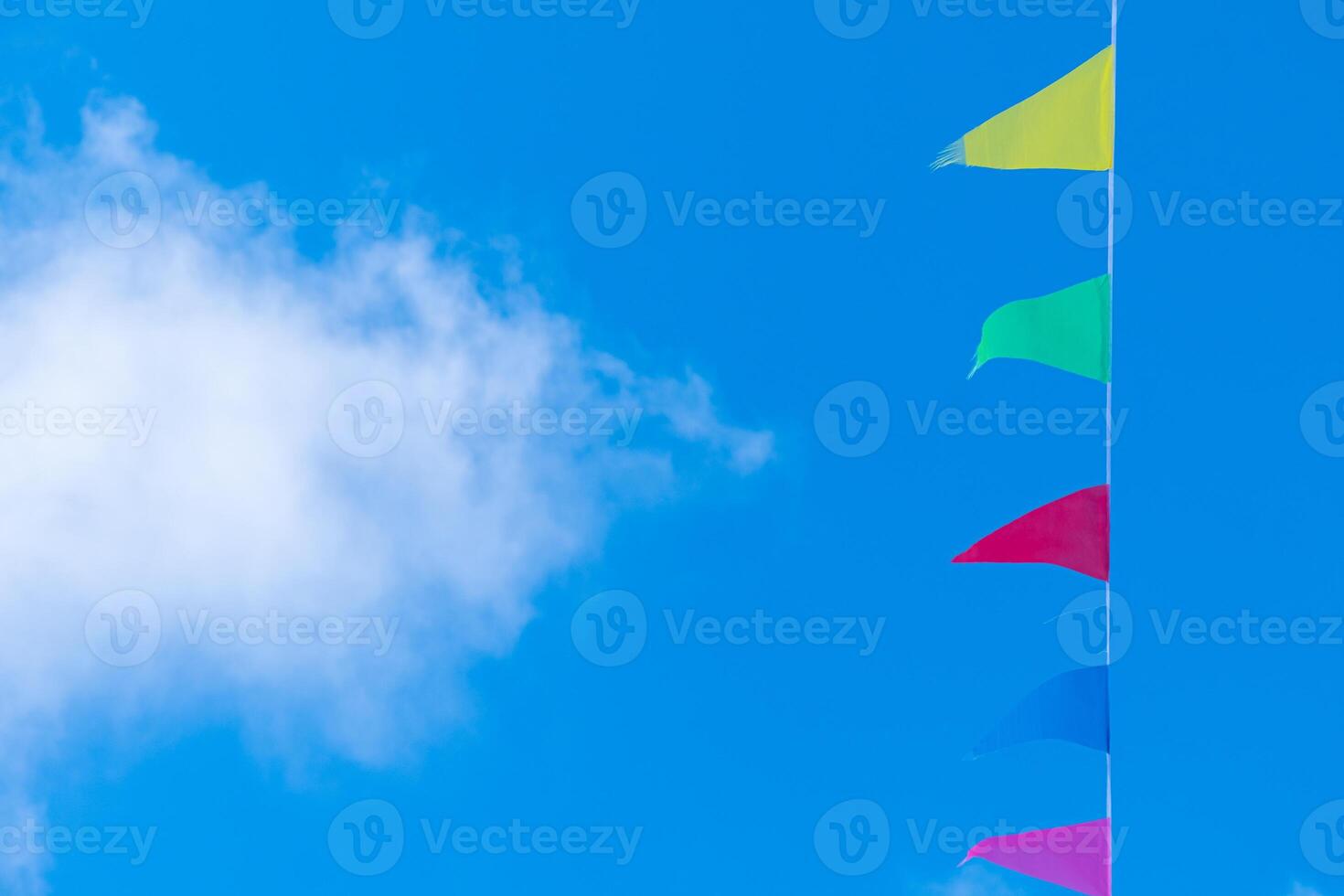 decorative colored pennants with a blue sky background and a cloud, decoration concept photo