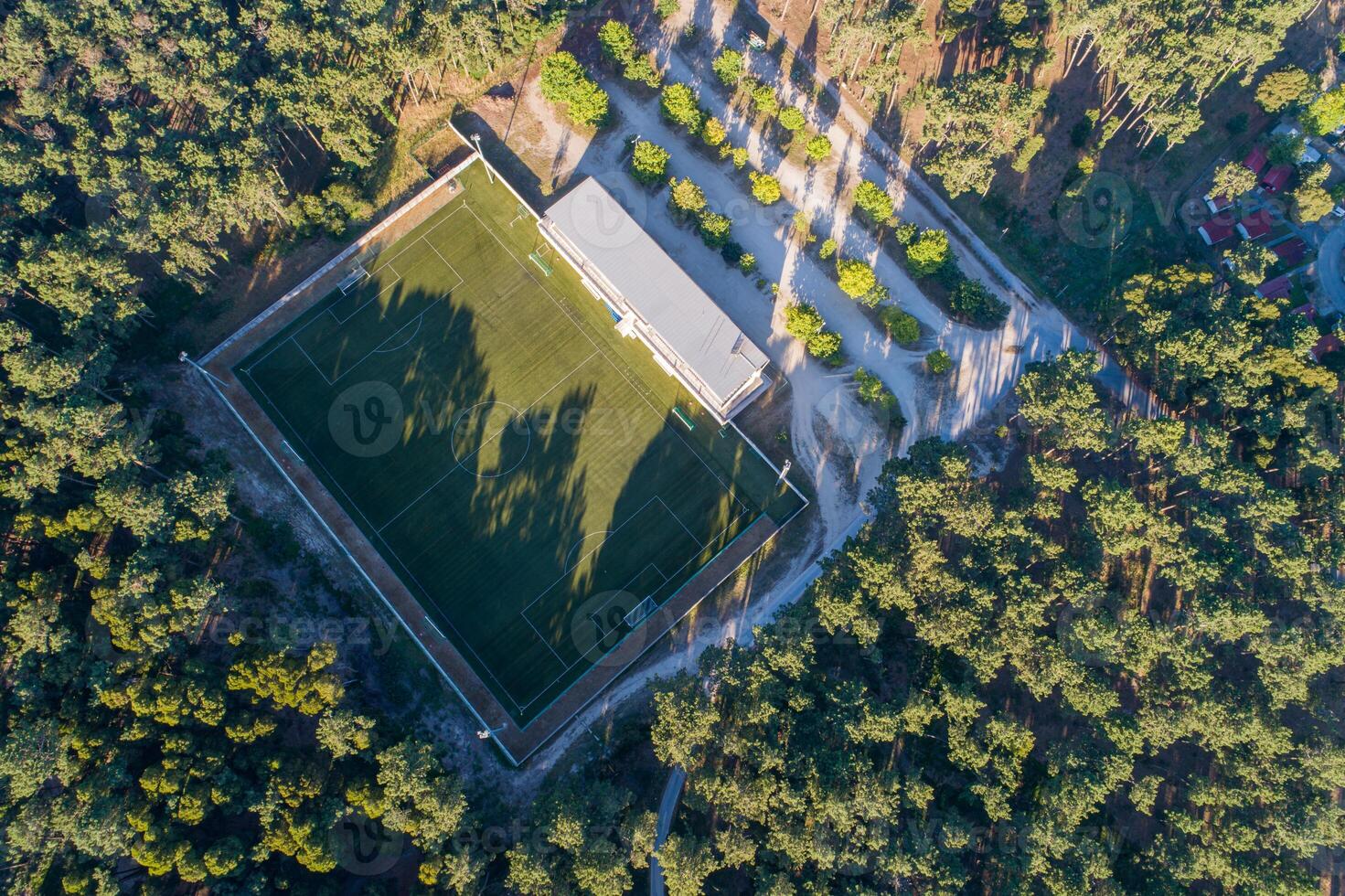 aerial view of a soccer field in a pine forest photo