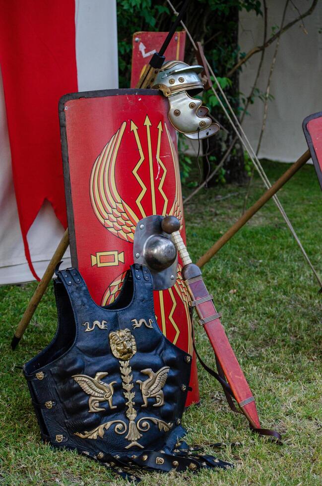 sword, armor, shield and helmet of roman legionary in a historical recreation festival photo