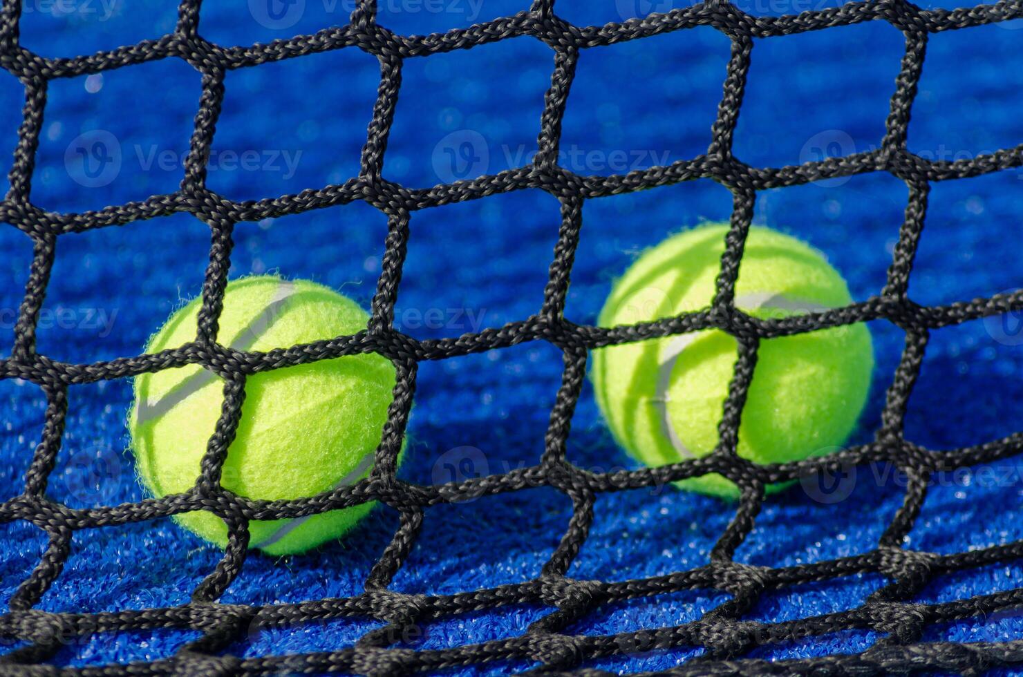 Paddle tennis, four balls behind the net photo