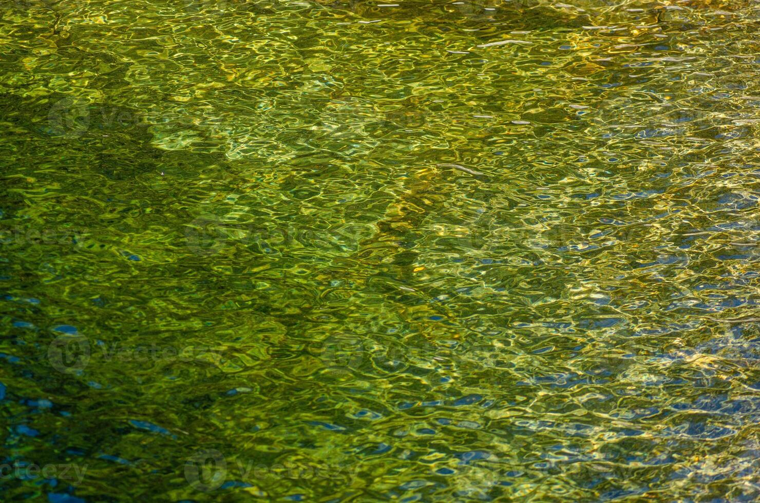 selective focus, detail of a stream of water on a granite soil. Texture photo