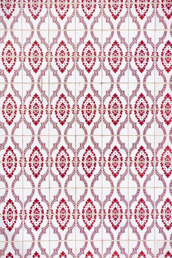 close-up view of a tiled wall with red geometric motifs photo