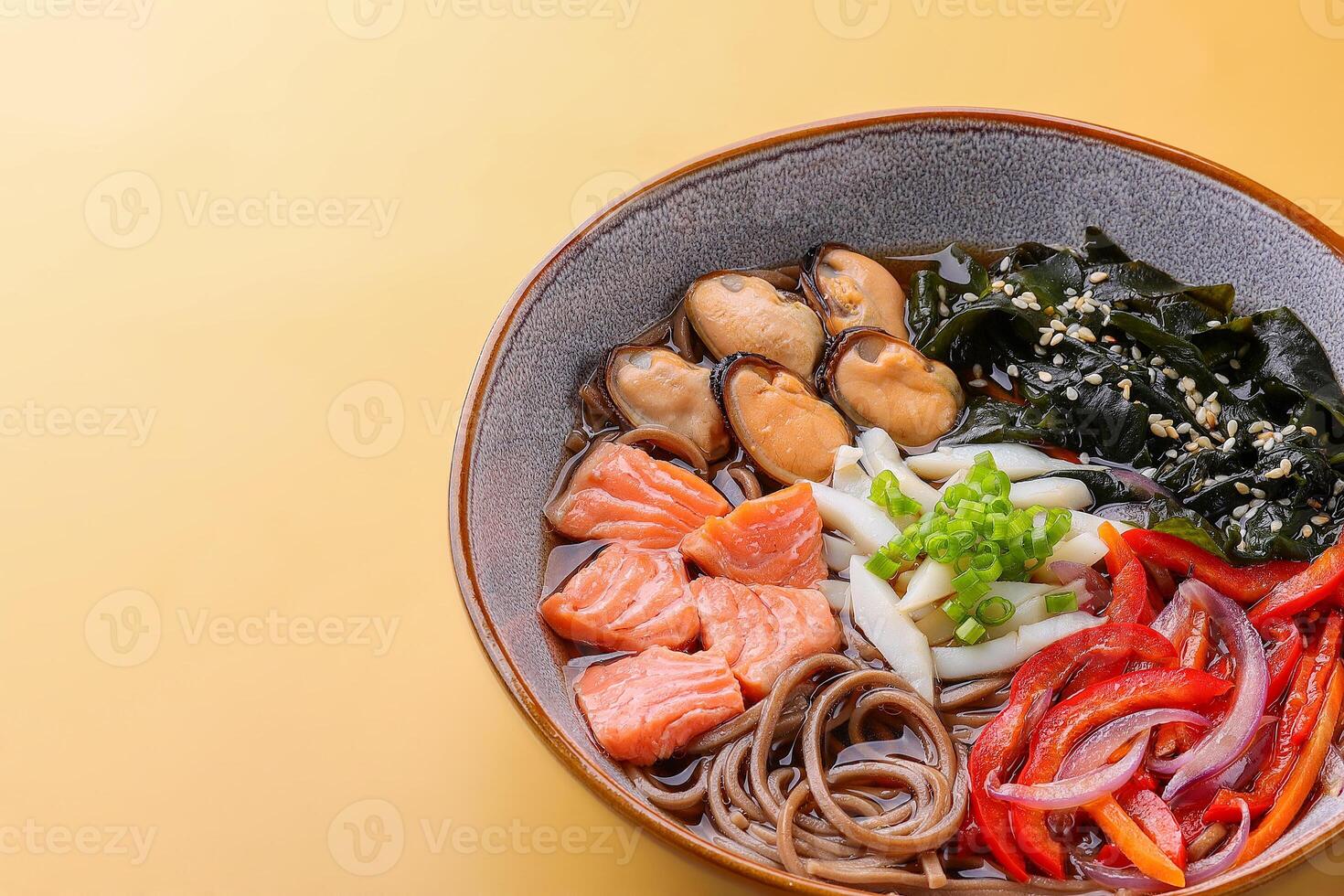 Japanese soup with seafood and noodles in a beautiful bowl photo