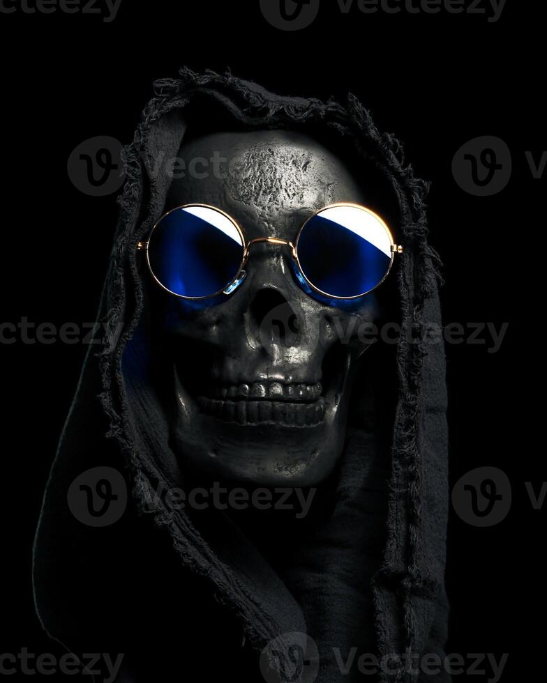 Hooded human skull with fun blue sunglasses. Cool Grim Reaper for Halloween costume. photo