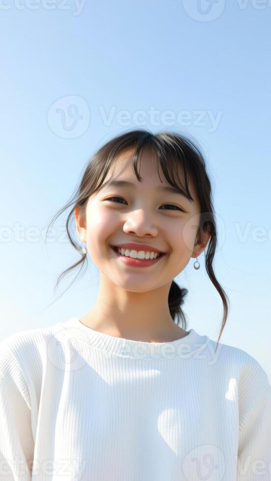Portrait of a Smiling Young Woman with Blue Sky Background photo