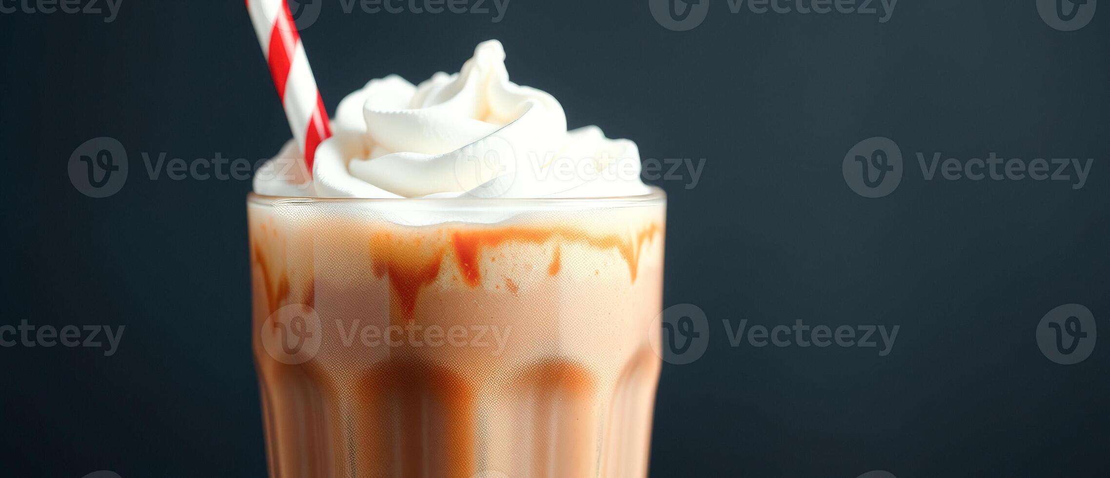 Caramel Milkshake with Whipped Cream and a Red and White Straw photo