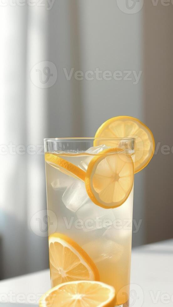 Lemonade with lemon slices and ice cubes in a glass photo