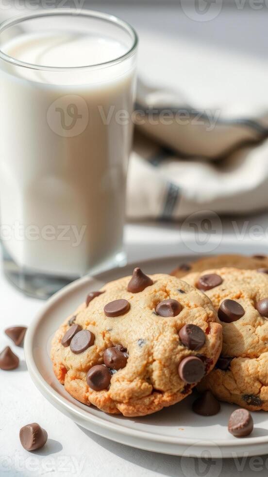 Close-up of Chocolate Chip Cookies and Milk on a White Surface photo