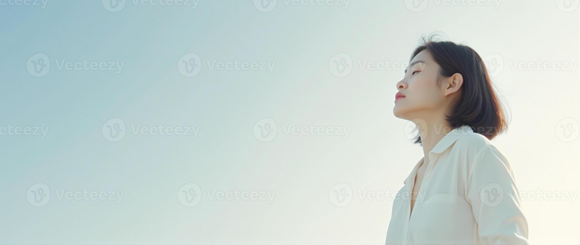 Woman in White Shirt Looking Up at the Sky photo