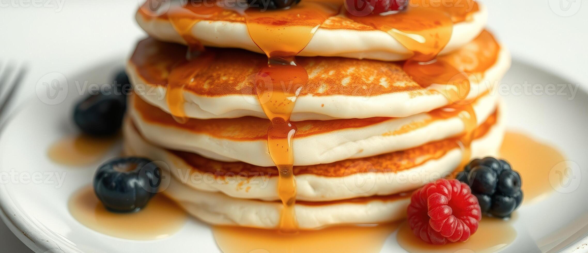 Close-up of Pancakes with Syrup and Berries photo