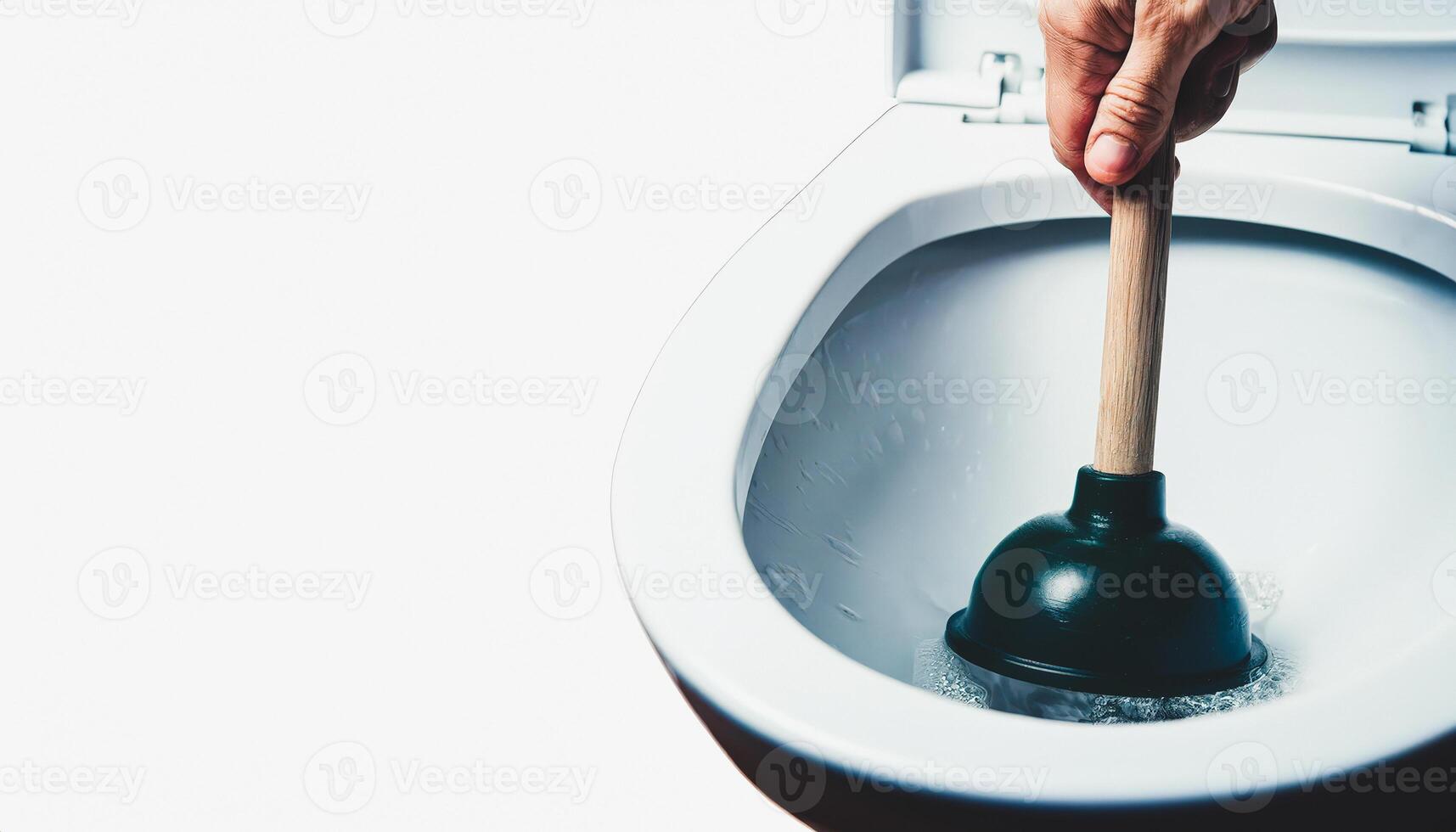 Closeup of Hand Using Plunger in Toilet Bowl photo
