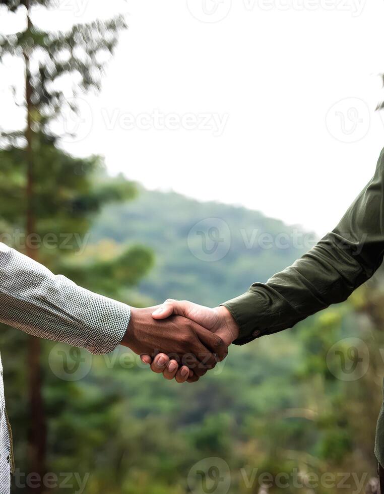Two Hands Shaking in a Forest Setting photo
