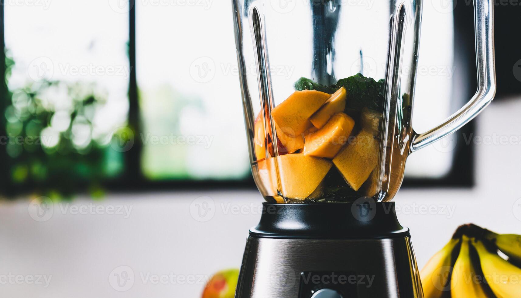 Closeup of a blender with fruit inside photo
