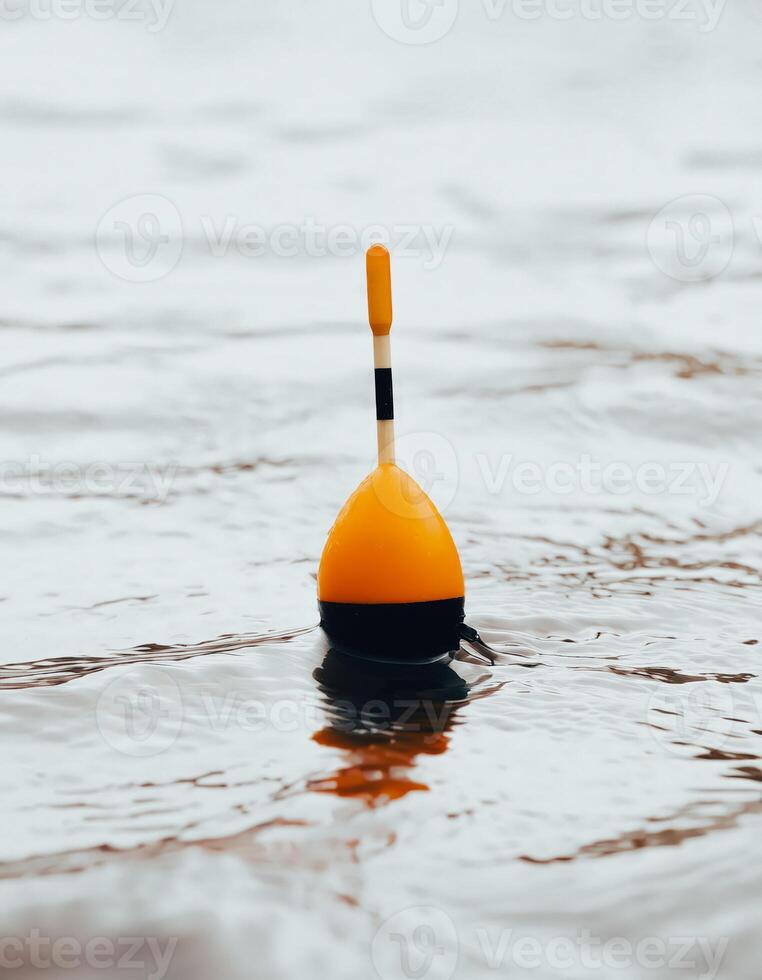 Orange Fishing Bobber Floating in Water photo