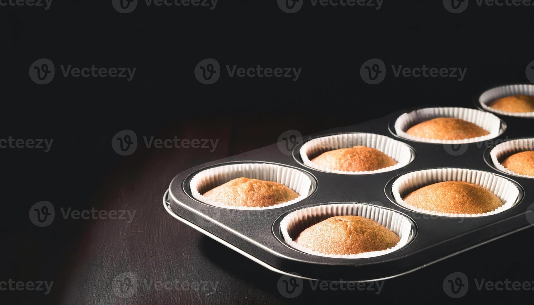 Closeup of freshly baked cupcakes in a muffin tin photo