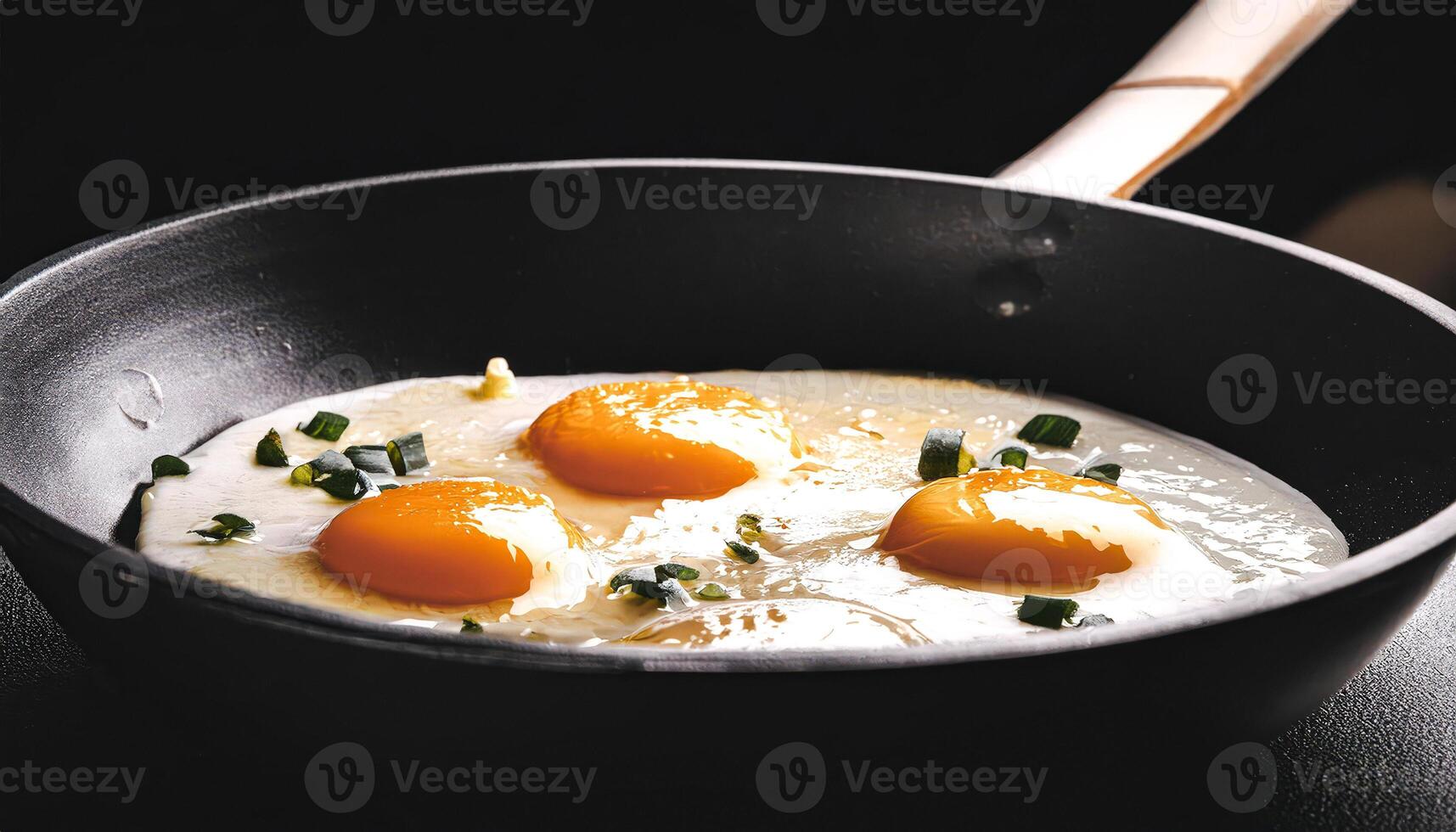 Sunny Side Up Eggs with Green Onions in a Black Pan photo
