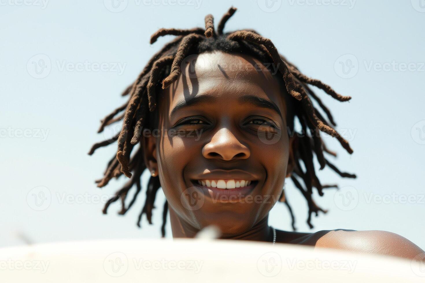 Close-up Portrait of a Smiling Man with Dreadlocks photo
