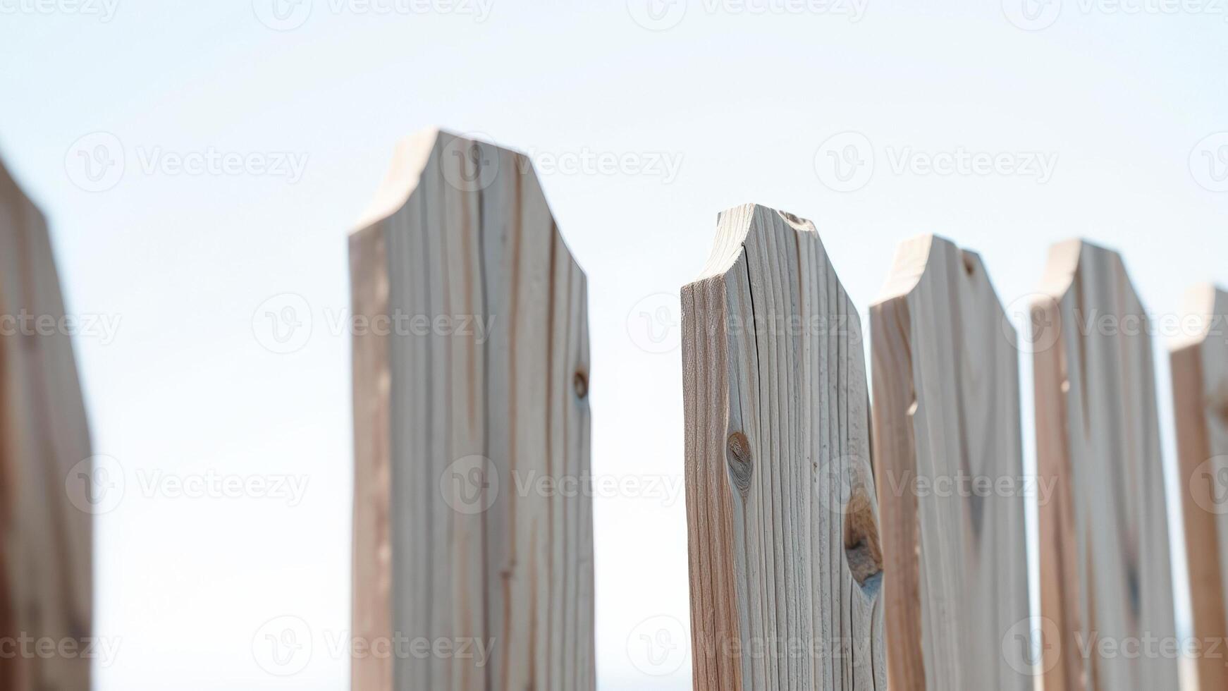 Close Up of Wooden Fence Against a Bright Blue Sky photo