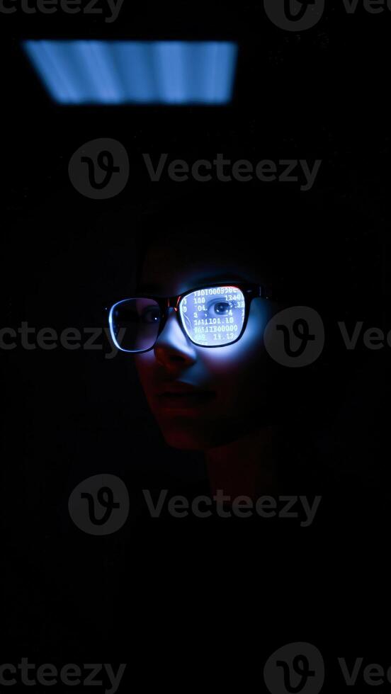 Person wearing glasses with digital numbers reflecting in the lenses photo