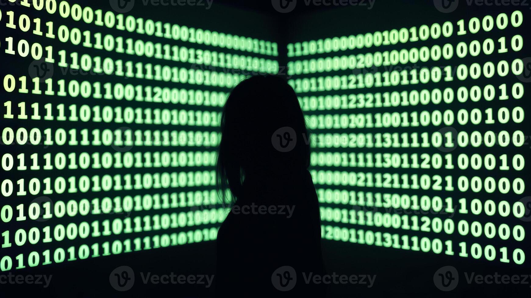 Silhouette of a person in front of a wall of binary code photo