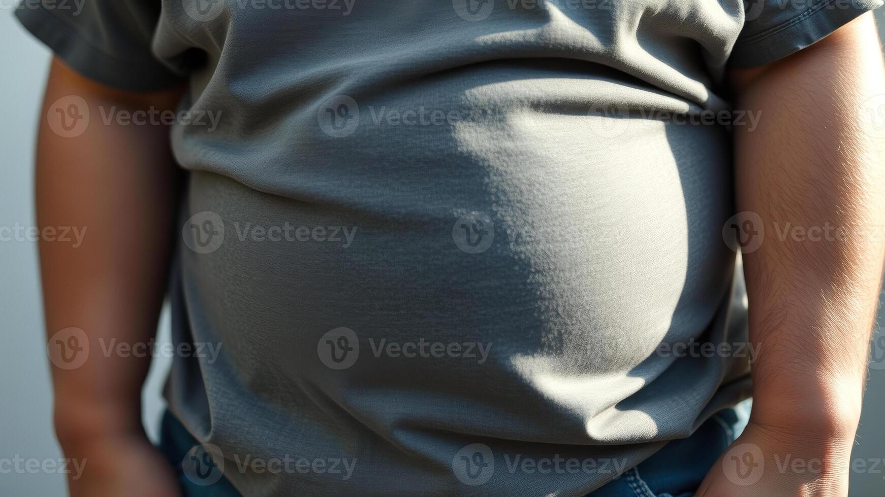 Close Up Of Man's Stomach In Grey T-Shirt photo