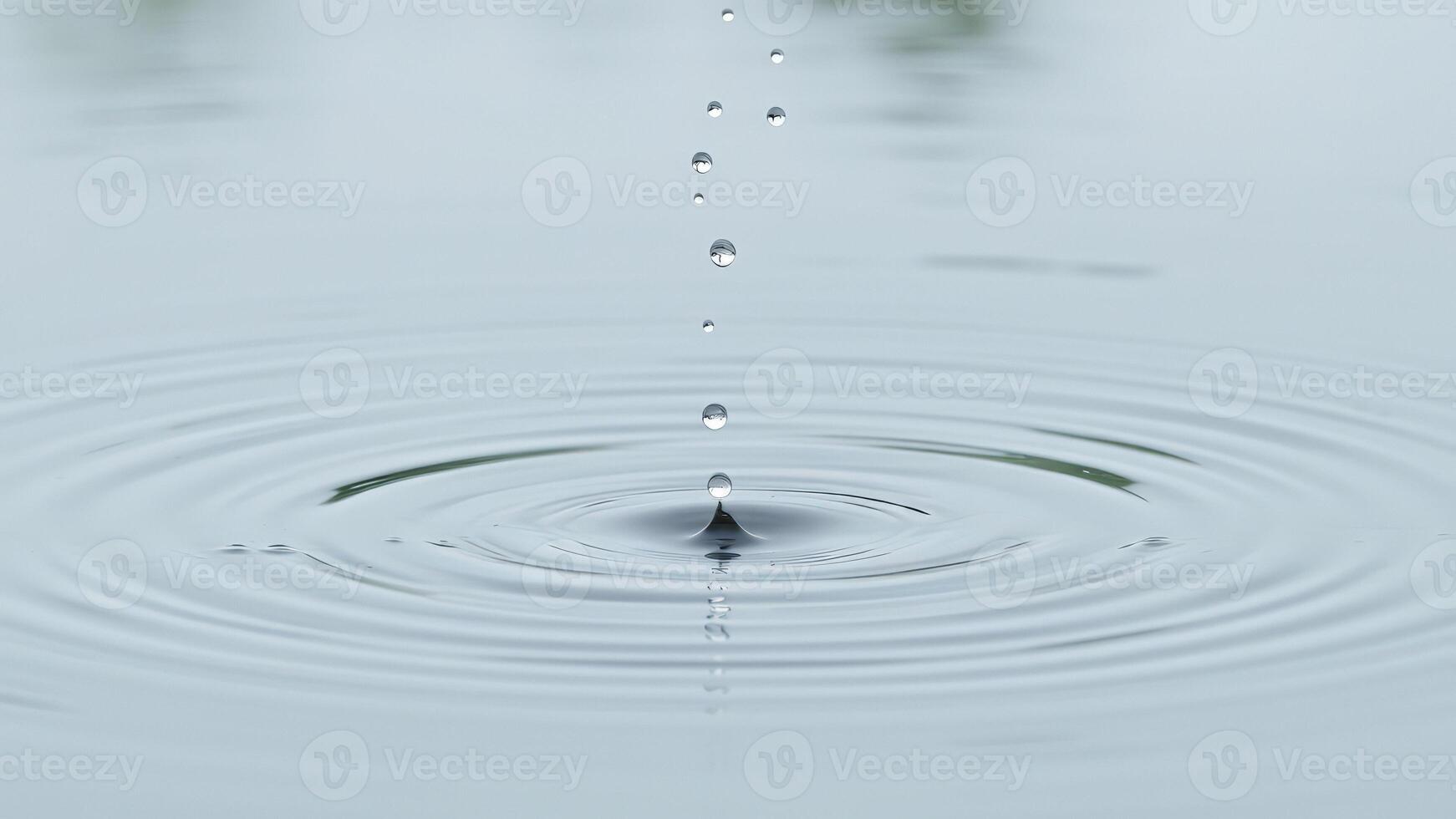 Water Droplet Creating Ripples in Still Water photo