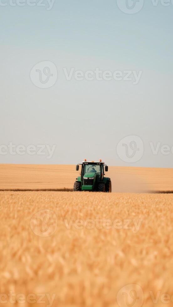 Tractor driving through a field of wheat photo