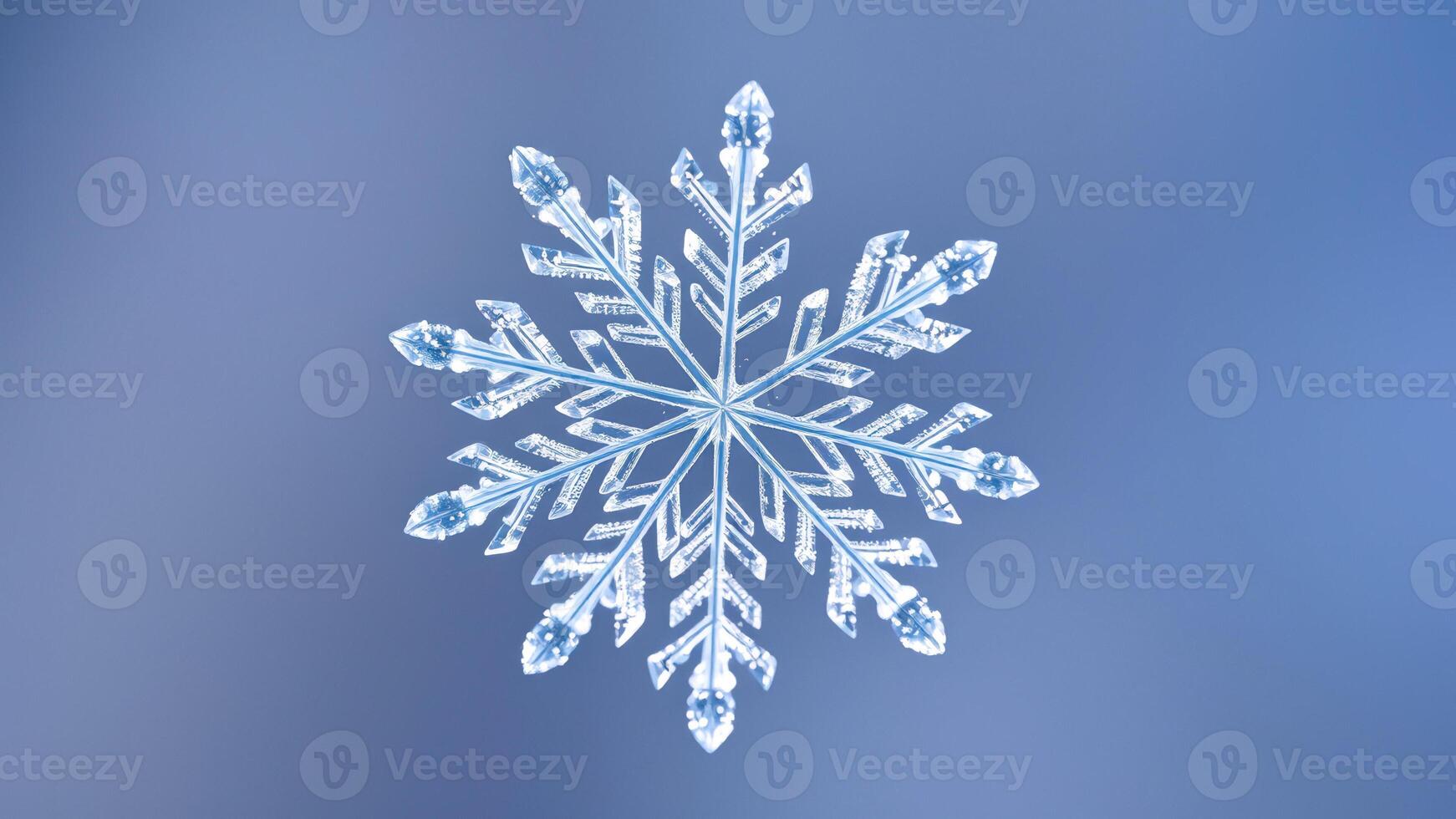 Close-up of a Single Snowflake on a Blue Background photo
