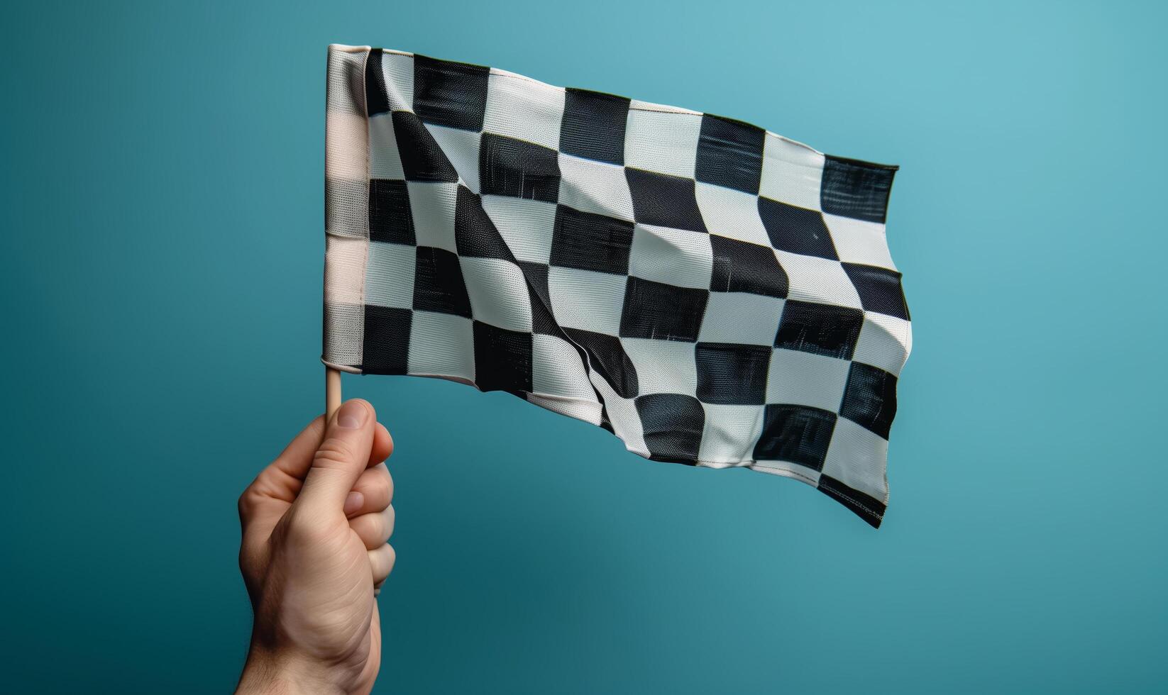 Checkered racing flag in male hand on blue background photo