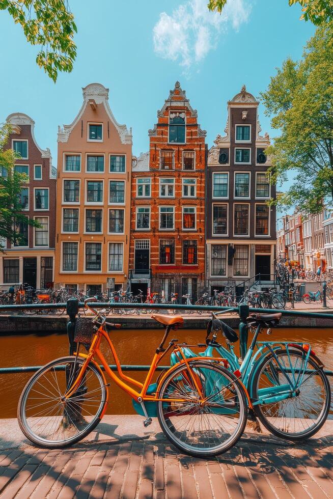 Colorful bicycles lined up along the canal in Amsterdam on a sunny day photo
