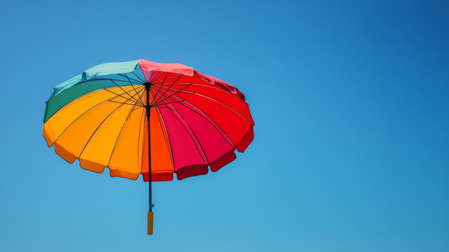 Colorful beach umbrella on sandy shore near pier during sunny day photo