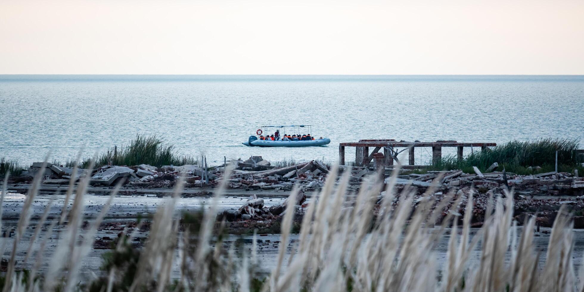 Miramar, Cordoba, Argentina - 22 June 2024 - Inflatable boat carrying tourists in the Laguna de Mar Chiquita. Ansenuza National Park. photo