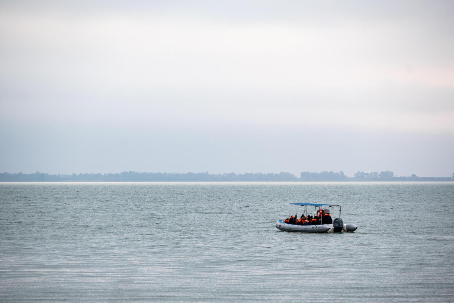 Miramar, Cordoba, Argentina - 22 June 2024 - Inflatable boat carrying tourists in the Laguna de Mar Chiquita. Ansenuza National Park. photo