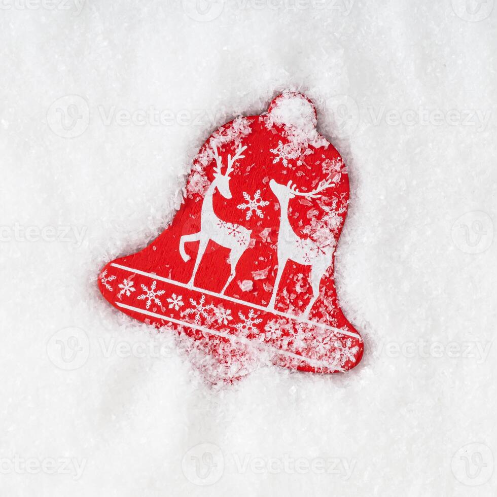 Red Christmas decoration with white reindeers and snowflakes on snowy background. Minimal creative Christmas and New year concept. Trendy festive winter holidays layout. Flat lay, top of view. photo