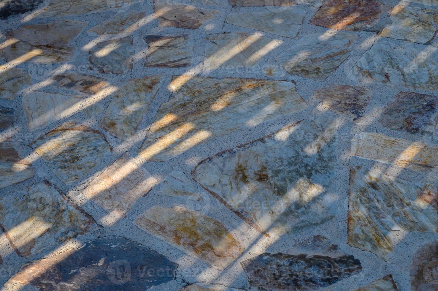 top view of the floor composed of travertine tiles in warm beige hues photo