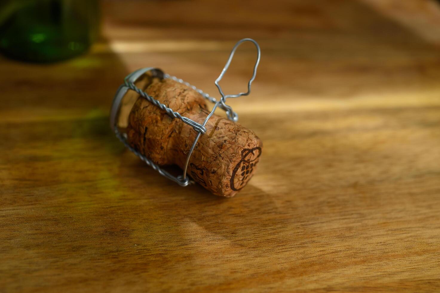 One champagne cork, on a wooden table on a white background photo