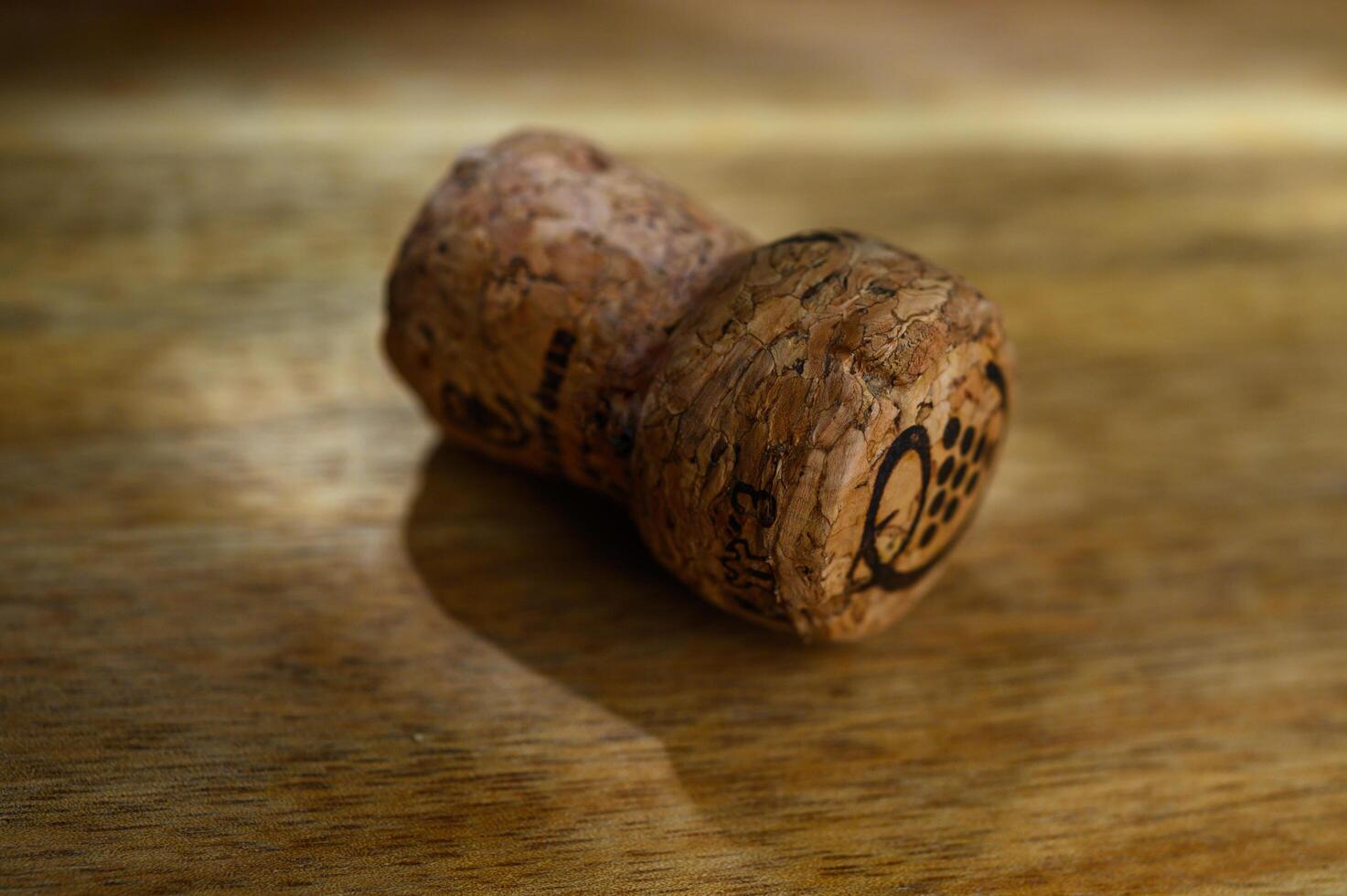 Champagne cork - on wooden background photo