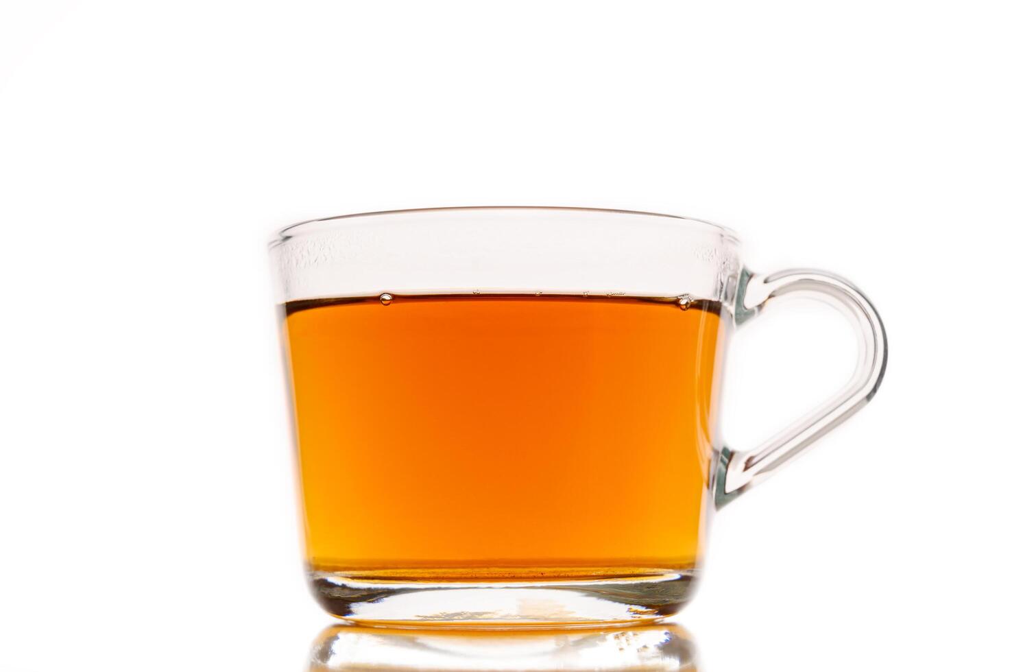 Transparent cup of tea on white background photo