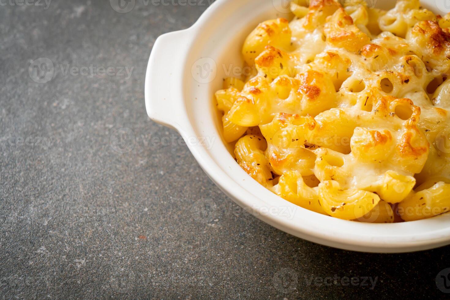 American mac and cheese, macaroni pasta in cheesy sauce photo