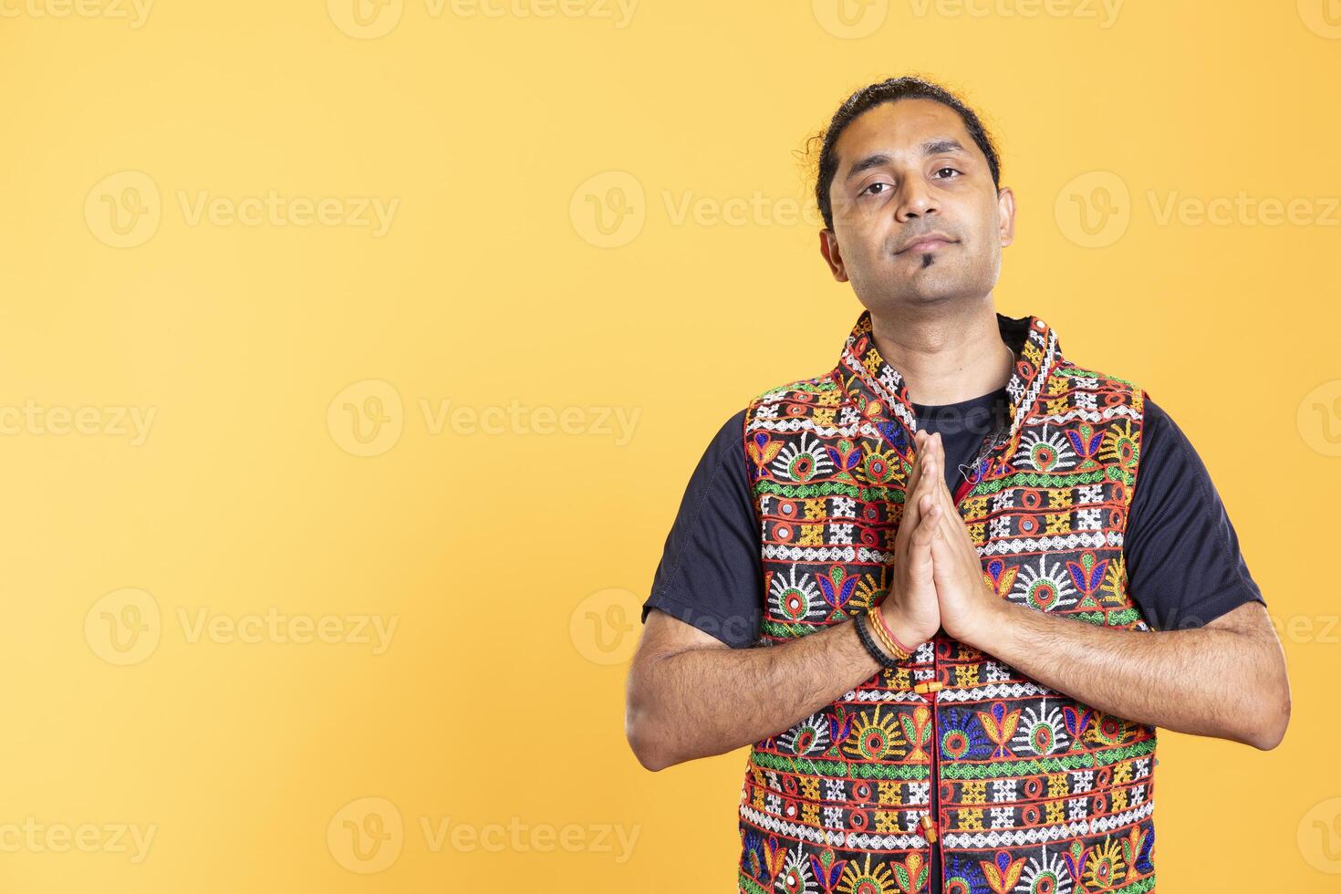 Portrait of calm man putting hands together, requesting help, isolated over studio background. Person in need of assistance soliciting aid, relying on friends to solve problem photo