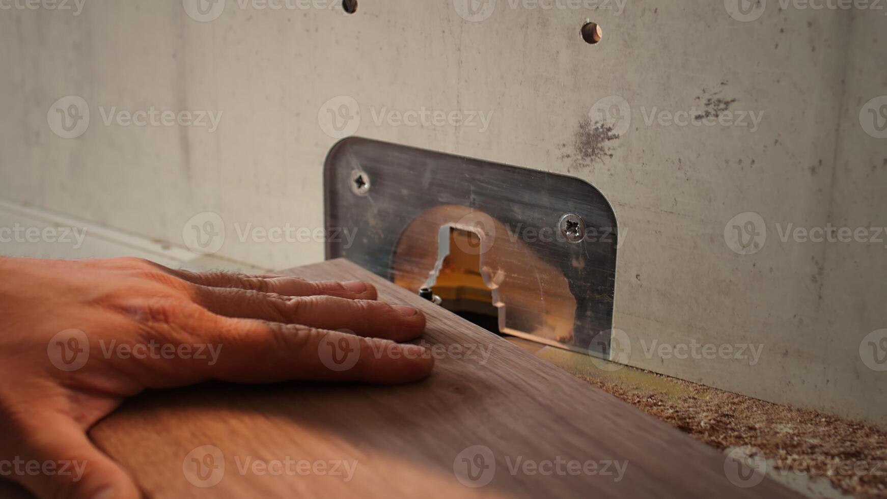 Woodworker operating spindle moulder to create high quality bespoke joinery for customer commissioned project. Machinist at work performing tasks on wood shaper, shaping materials, camera B close up photo