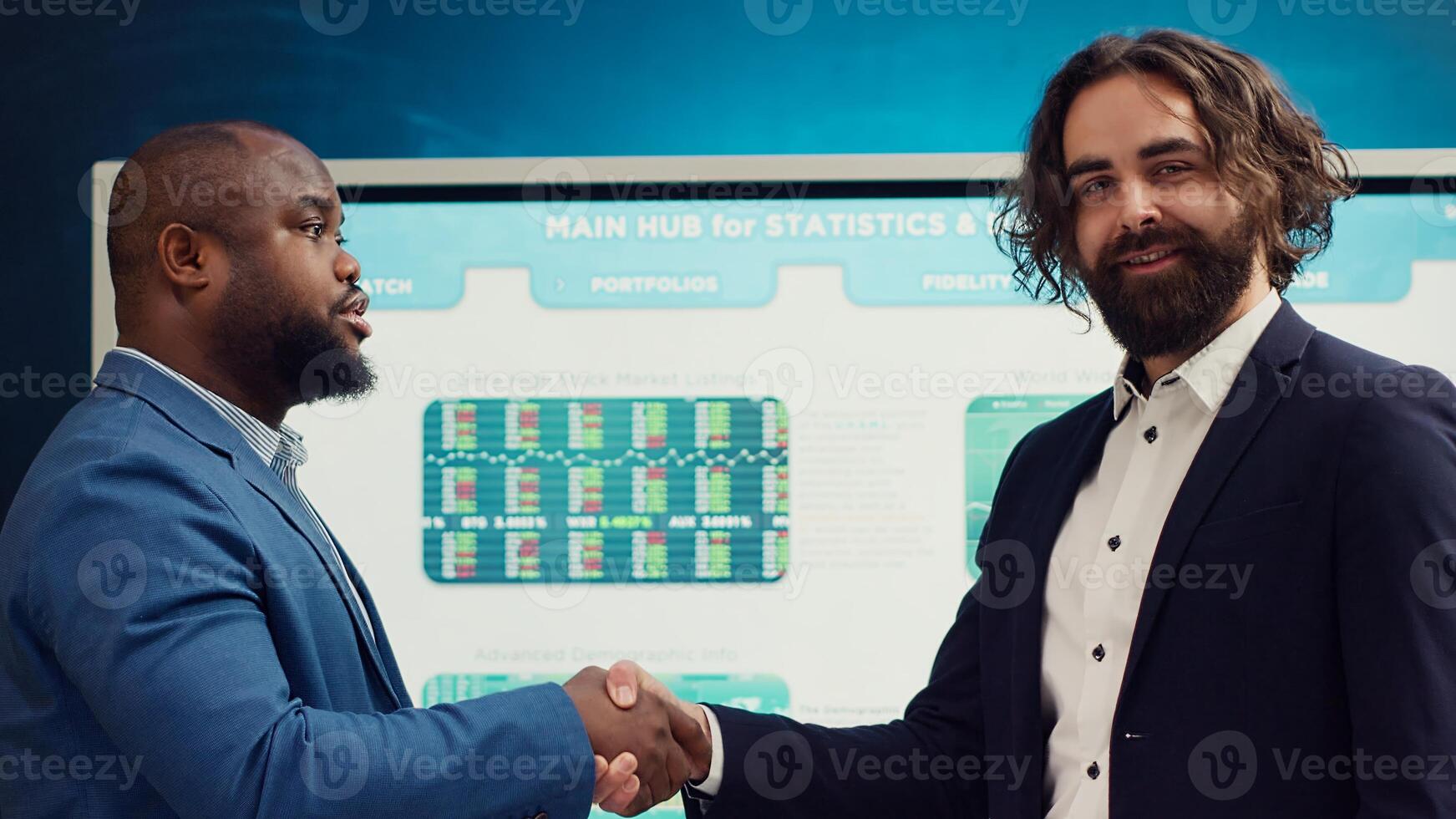 Business partners celebrate the beginning of a new project between their companies, shaking hands in a meeting. Leaders forging an agreement to develop the corporation and collect resources. Camera A. photo