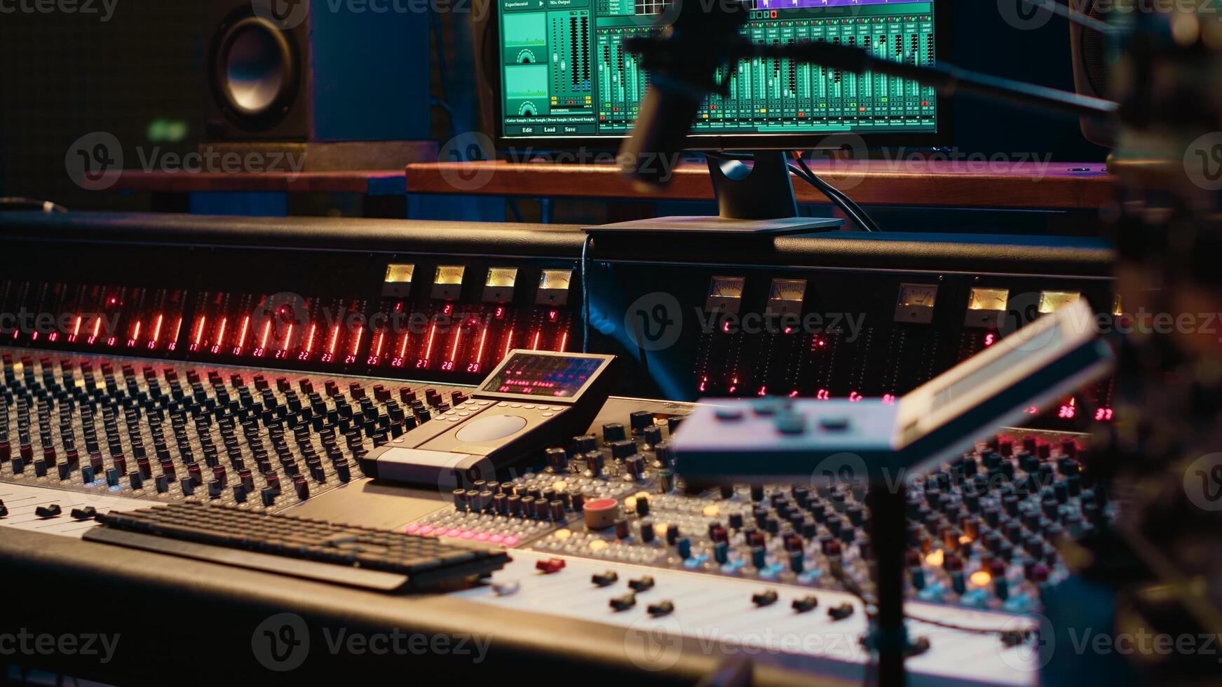 Control room with technical equipment and music recording software, professional studio editing and producing tracks. Audio console with moving faders and colored meters, high quality sounds. photo