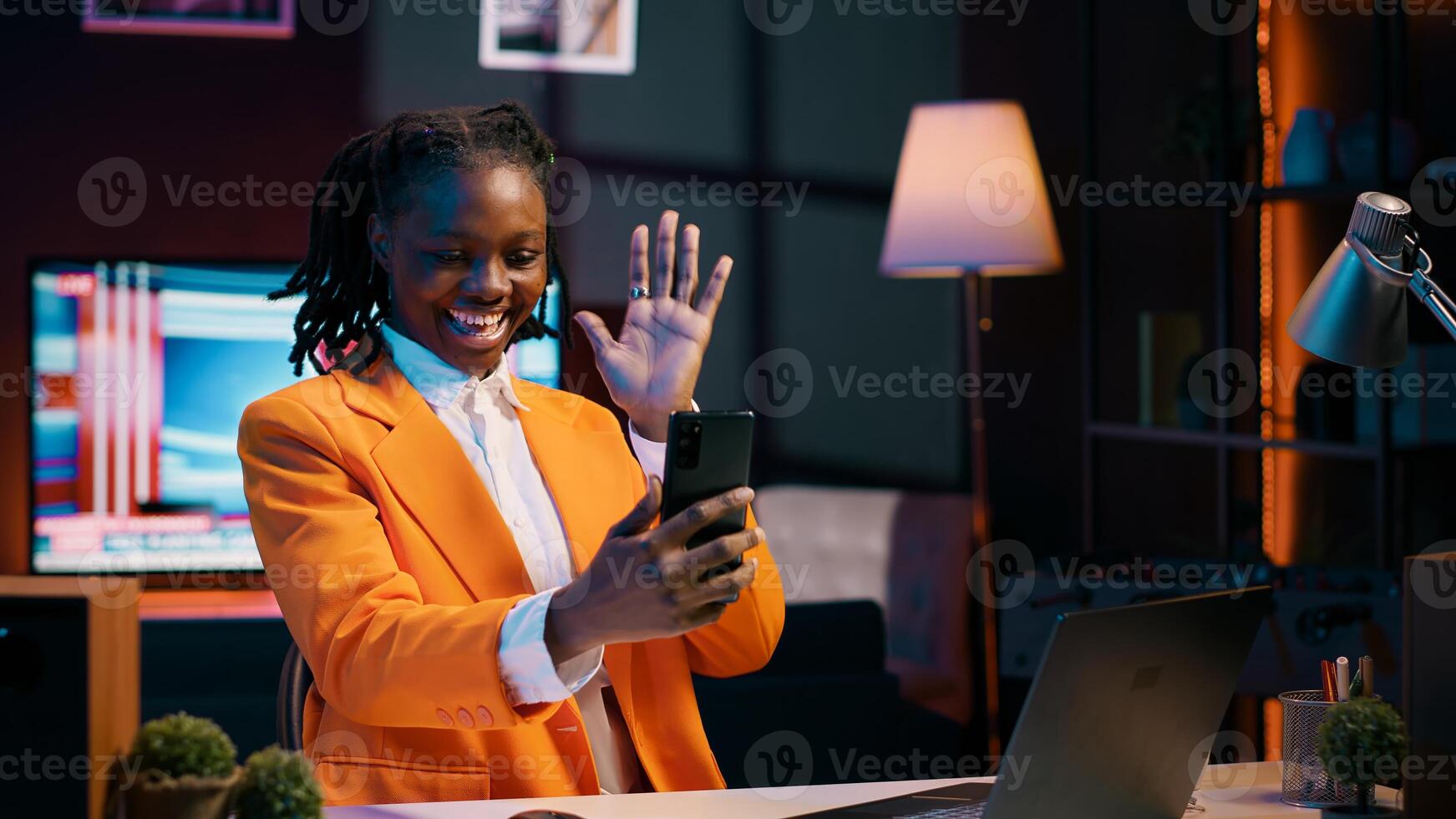 African american student attending online career course in videocall, using smartphone to meet remotely with classmates and professor. Pupil discussing about assignments with tutor. Camera A. photo