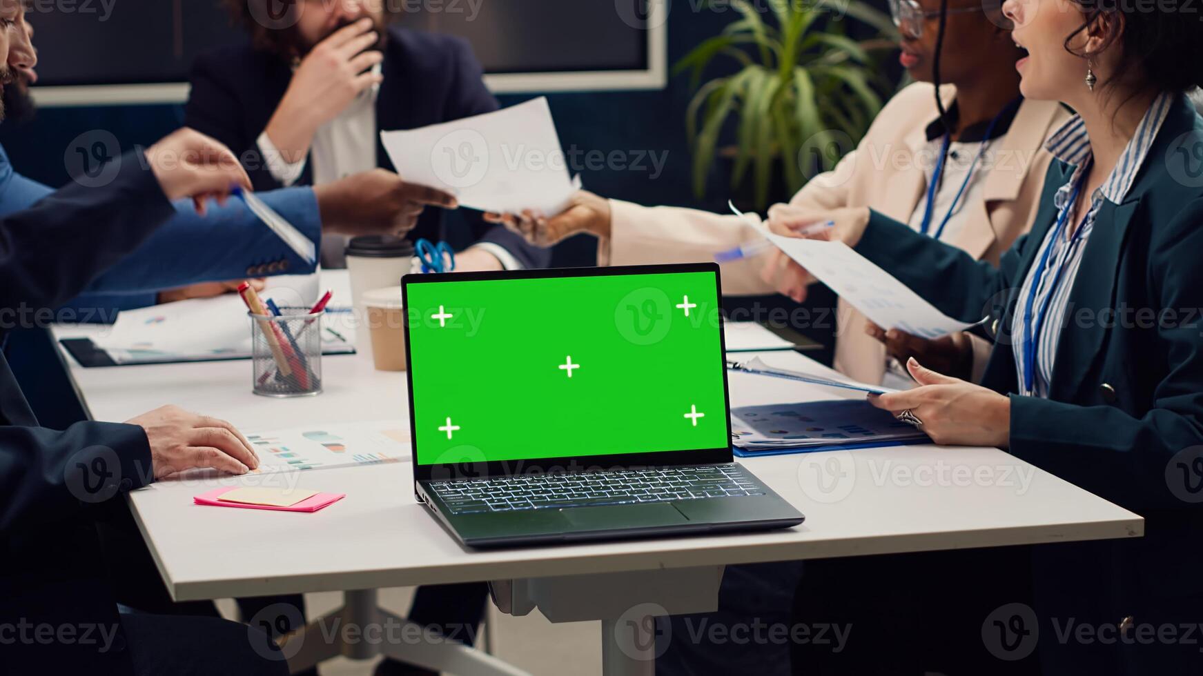 Business people meeting in a boardroom office with greenscreen display, presenting updates on project and sharing insight on research. Corporate colleagues reviewing gathered info. Camera A. photo